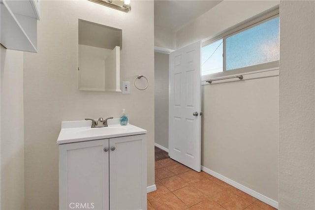 bathroom featuring vanity, baseboards, and tile patterned floors