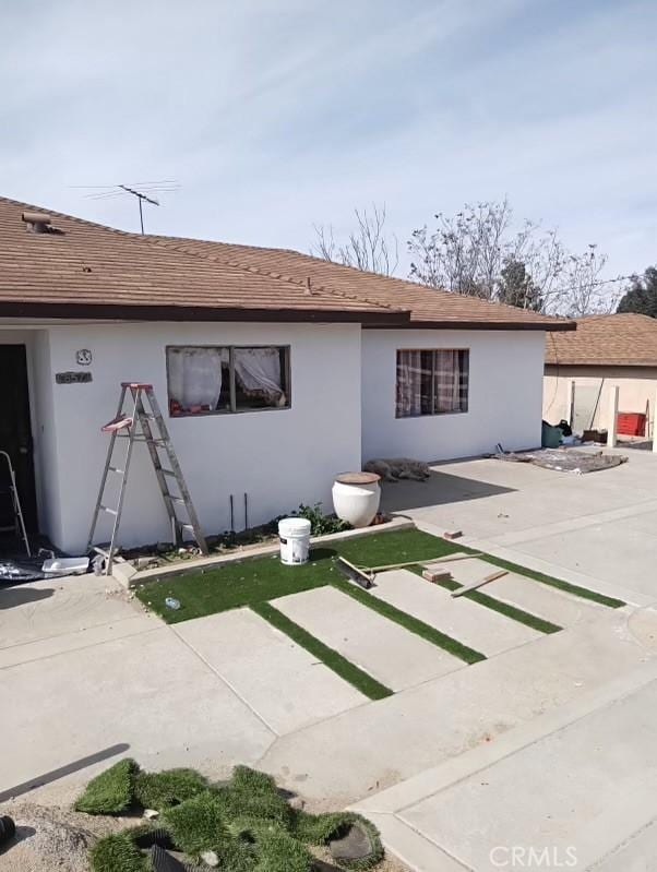 back of property with a patio area and stucco siding