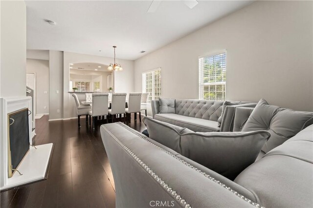 1339 Castledale St, Riverside, CA 92501 - living room with baseboards, dark wood-style flooring, and a chandelier