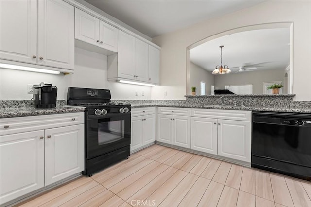 kitchen with stone countertops, a sink, a ceiling fan, white cabinets, and black appliances