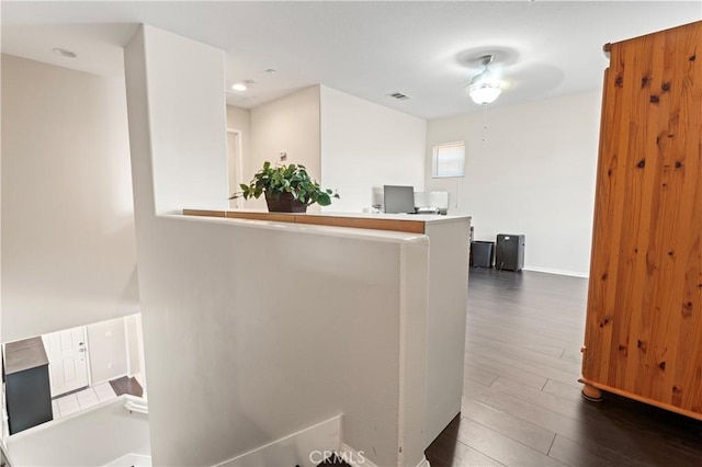 interior space with dark wood-style floors, baseboards, and visible vents