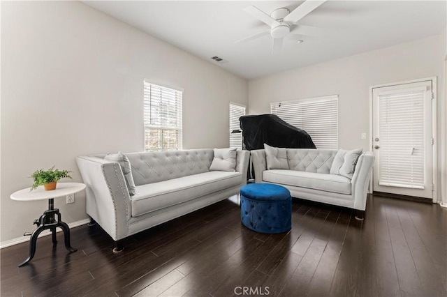 living area featuring wood finished floors, visible vents, and baseboards