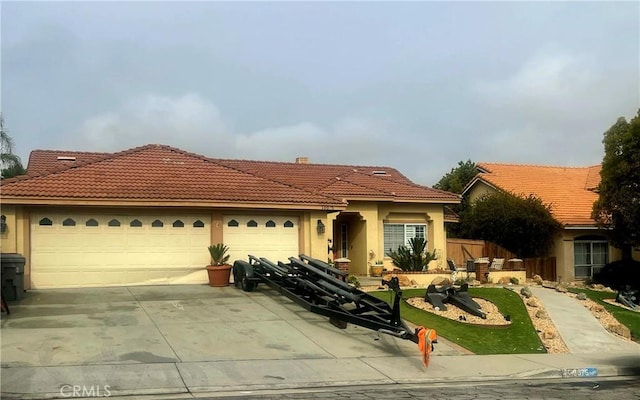 mediterranean / spanish-style home with a garage, driveway, a tiled roof, and stucco siding