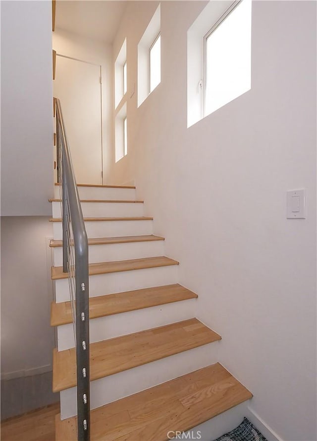 stairs featuring wood finished floors