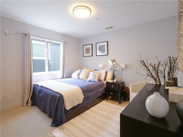 bedroom featuring baseboards, visible vents, and carpet flooring