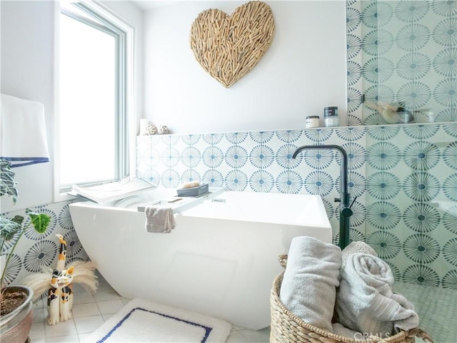 full bath with tile patterned flooring and a freestanding bath