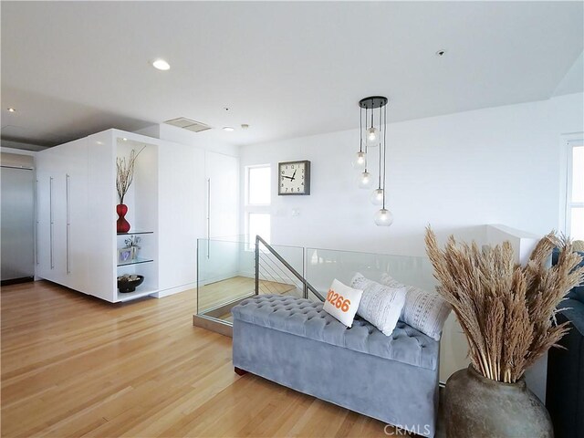 living area featuring light wood finished floors, visible vents, and recessed lighting