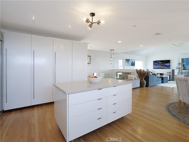 kitchen with a center island, modern cabinets, white cabinets, and open floor plan