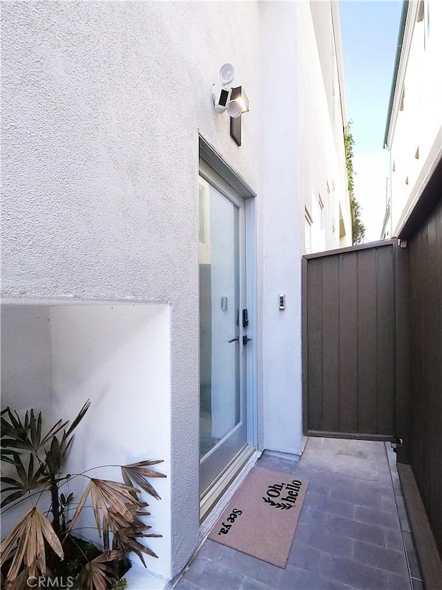 property entrance with stucco siding