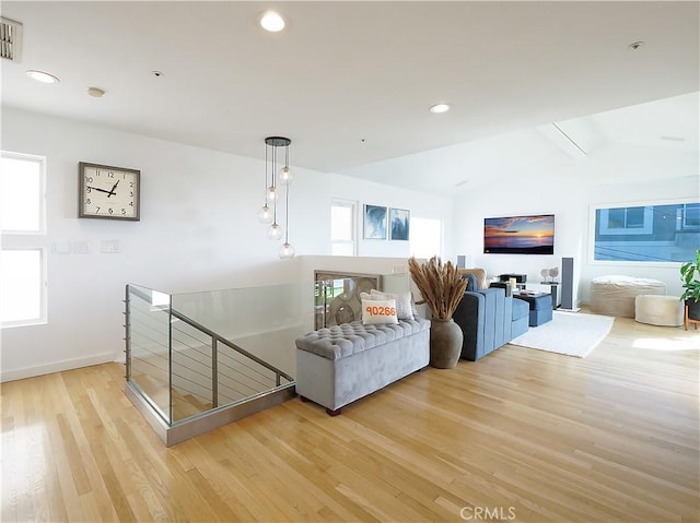 living room featuring a healthy amount of sunlight, light wood finished floors, vaulted ceiling, and recessed lighting