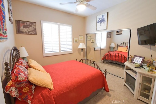 carpeted bedroom featuring a ceiling fan and multiple windows