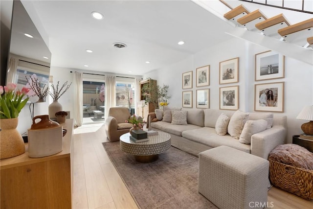 living room featuring recessed lighting, visible vents, and light wood finished floors