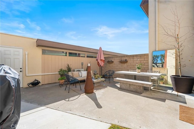 view of patio featuring fence, an outdoor living space, and grilling area