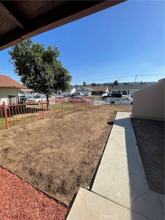 view of yard featuring a residential view and fence