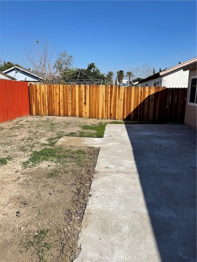 view of yard with a fenced backyard and a patio