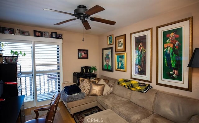 living room featuring ceiling fan and wood finished floors