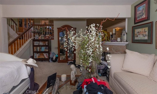 living area featuring stairs and carpet flooring