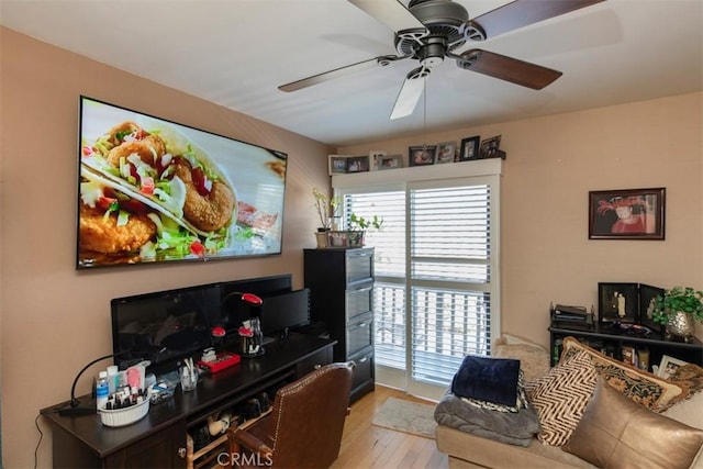 living room featuring ceiling fan and light wood finished floors