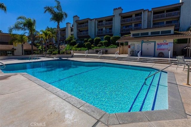 pool featuring a patio and fence