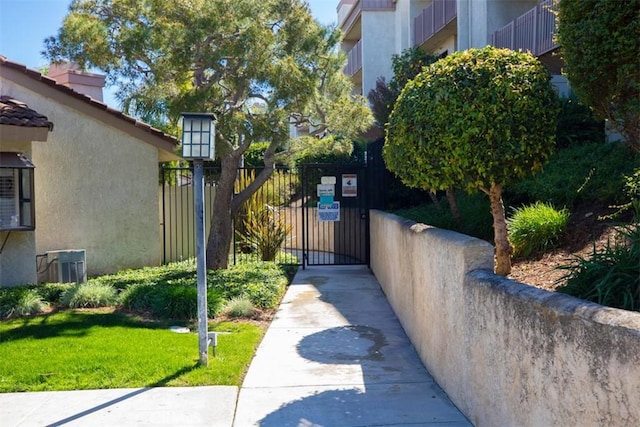 view of home's community featuring a gate and fence