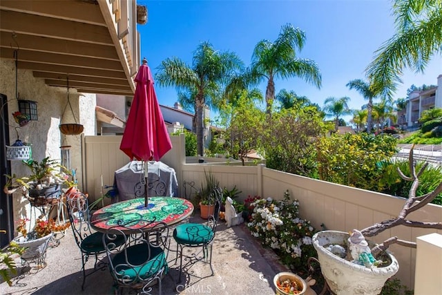 view of patio / terrace with outdoor dining space and fence