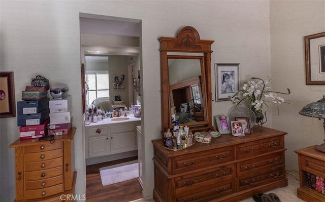 bedroom featuring a sink and ensuite bath