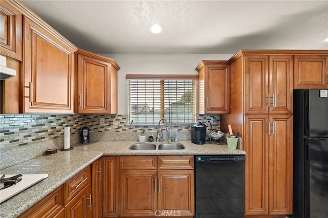 kitchen featuring black appliances, brown cabinetry, a sink, and decorative backsplash