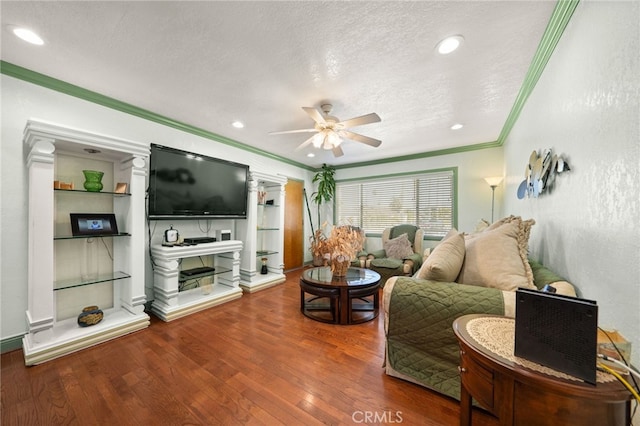 living area with ornamental molding, ceiling fan, a textured ceiling, and hardwood / wood-style flooring