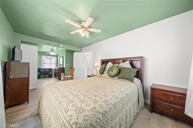 bedroom with a ceiling fan and wood finished floors