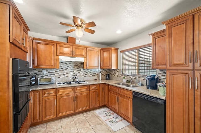 kitchen with black dishwasher, a sink, gas stovetop, and brown cabinets