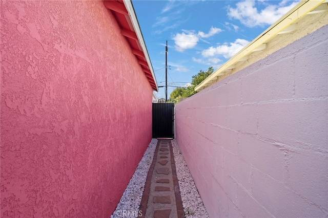 view of property exterior with fence and stucco siding