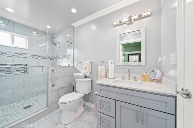 bathroom with toilet, vanity, marble finish floor, ornamental molding, and a stall shower