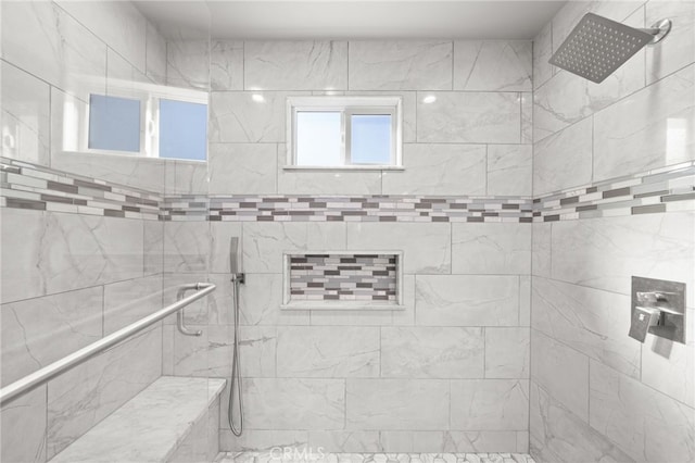 bathroom with tiled shower