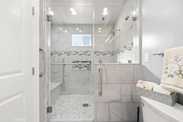 full bathroom featuring recessed lighting, a shower stall, and toilet