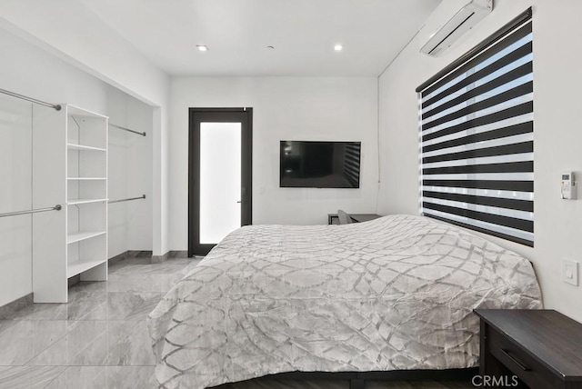 bedroom with recessed lighting, marble finish floor, a wall unit AC, and baseboards