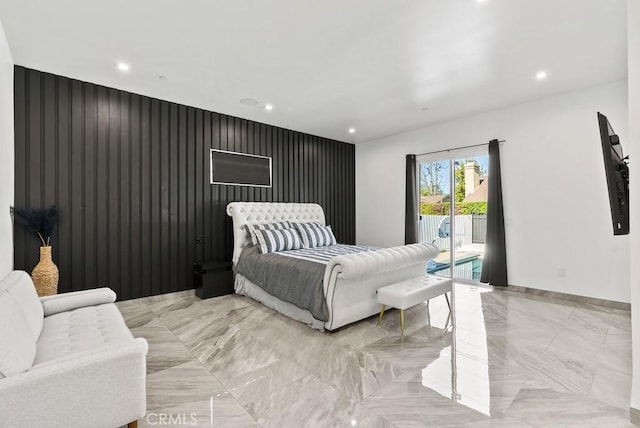 bedroom with access to outside, an accent wall, and recessed lighting