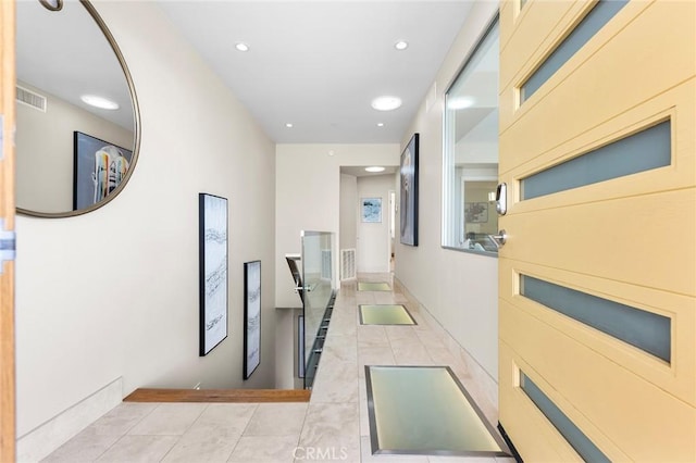 hall with recessed lighting, visible vents, and light tile patterned floors