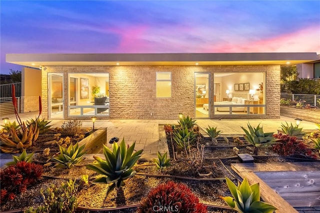 rear view of property featuring a patio area and fence