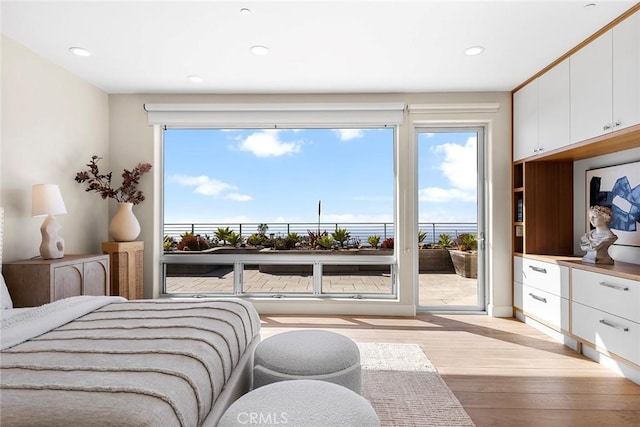 bedroom featuring access to outside, multiple windows, light wood-style flooring, and recessed lighting