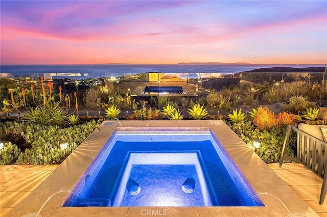 view of swimming pool featuring a patio area and an in ground hot tub