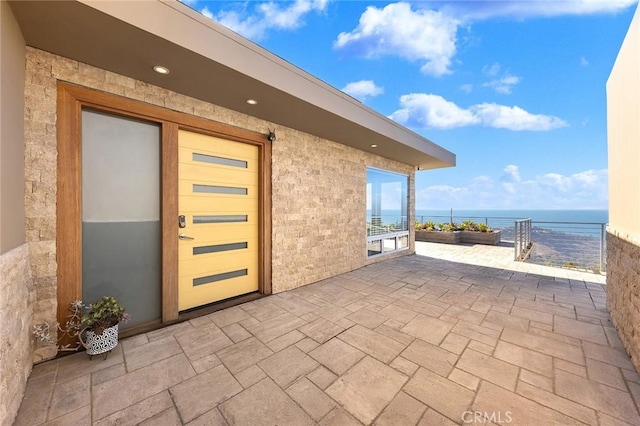 view of patio with a water view