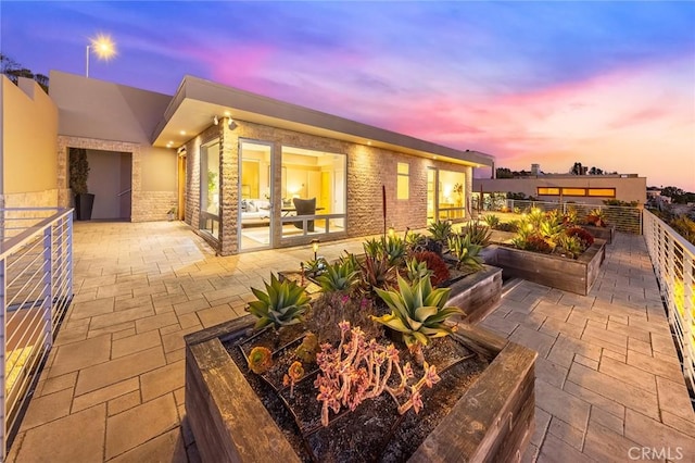 view of patio terrace at dusk