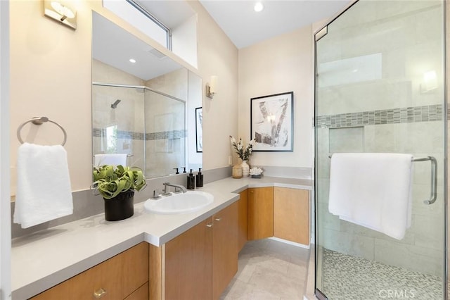 bathroom with recessed lighting, a shower stall, and vanity