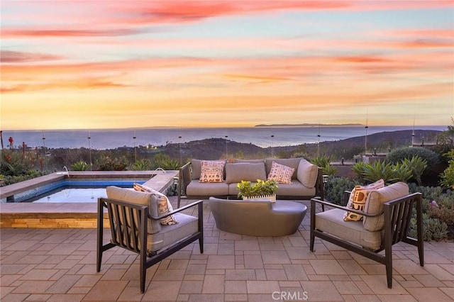 view of patio / terrace featuring a water view and outdoor lounge area