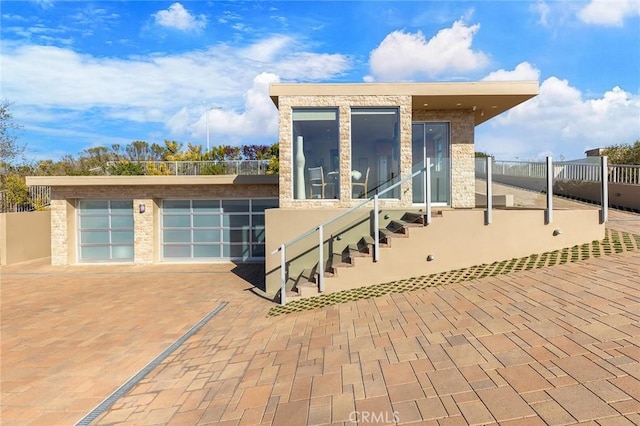 exterior space with a garage, fence, and a sunroom