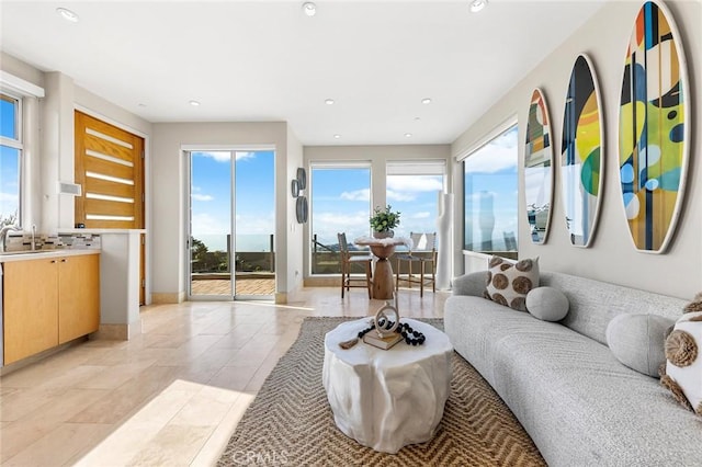 living area with light tile patterned floors, recessed lighting, and baseboards