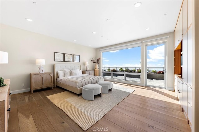 bedroom featuring access to outside, baseboards, recessed lighting, and hardwood / wood-style flooring