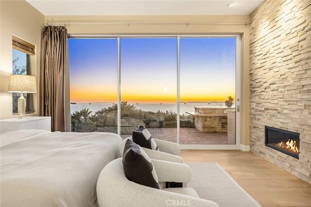 3355 Alta Laguna Blvd, Laguna Beach, CA 92651 - bedroom featuring wood finished floors, a water view, and a fireplace