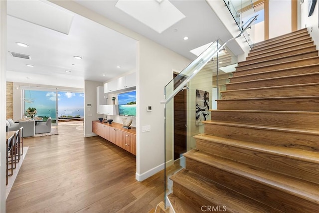 3355 Alta Laguna Blvd, Laguna Beach, CA 92651 - staircase with a skylight, wood finished floors, and recessed lighting
