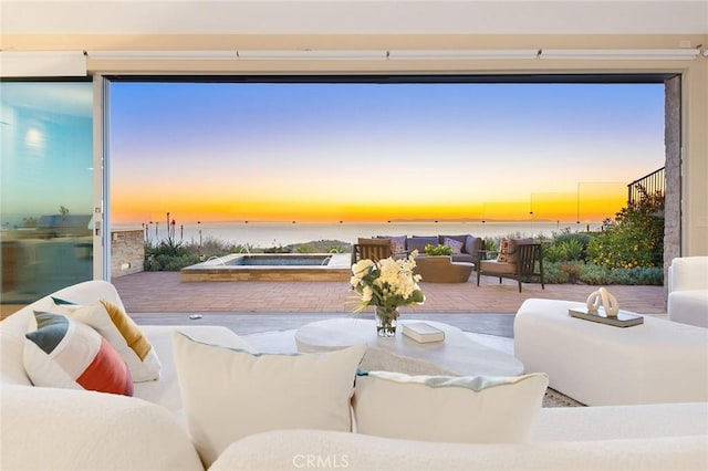 3355 Alta Laguna Blvd, Laguna Beach, CA 92651 - patio terrace at dusk with an outdoor hot tub, outdoor lounge area, a water view, and a patio